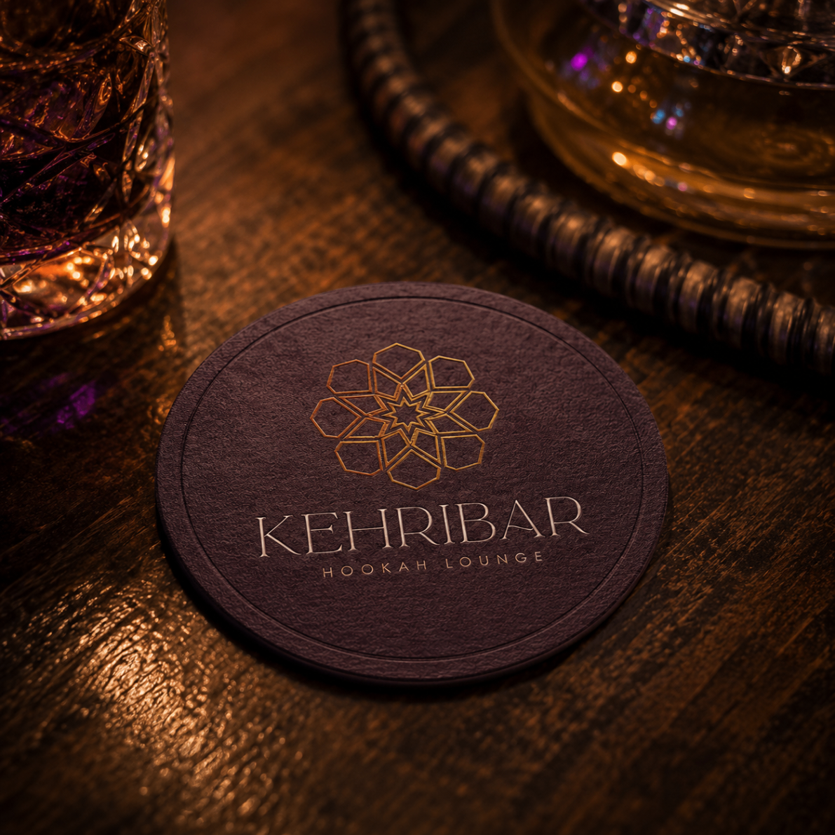 Kehribar branded coaster in deep purple with gold logo and wordmark